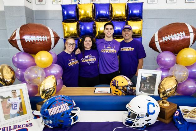 Childress High School senior Jacob Mora sings a National Letter of Intent to continue his football career with the Hardin-Simmons University Cowboys Thursday, Jan. 29 in the Childress High School gymnasium foyer.