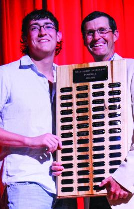Wellington High School senior Dalton Holland receives the Football Outstanding Lineman Award, presented by Athletic Director Greg Proffitt.