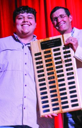 Wellington High School senior Nick Nevarez accepts the Football Larry Wright Memorial Award, presented by Athletic Director Greg Proffitt.