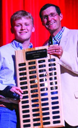 Wellington High School senior Trenton Wright receives the Football Larry Wright Memorial Award, presented by Athletic Director Greg Proffitt.