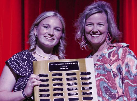 Sophomore Oakley Folk accepts the Most Improved Girls award for tennis, presented by Coach Amy Inman.