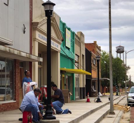 Crews erect downtown light poles