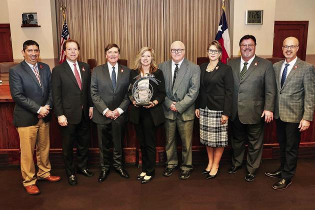 Texas Department of Transportation (TxDOT) Childress District Traffic Safety Specialist Nicole Tyler, center, is presented with the GRIT Award by the Texas Transportation Commission Tuesday, Dec. 13 in Austin. From left: Director of Traffic Safety Michael Chacon, Commissioner Robert C. Vaughn, Chairman J. Bruce Bugg, Jr., Tyler, Childress District Engineer Darwin Lankford, Commissioner Laura Ryan, Commissioner Alvin New and Texas Department of Transportation Executive Director Marc Williams. Courtesy Photo