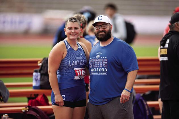 Childress’ Taylor Wiseman, joined by throwing coach Kolby Pool, sets a new Class 3A state record in shot put Thursday, May 1 at the UIL State Track and Field Championships in Austin.