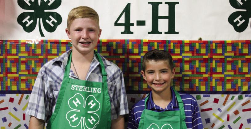 Quay Bruce, right, receives his Clover Apron, alongside former Clover Apron recipient and brother Sterling Bruce, left.