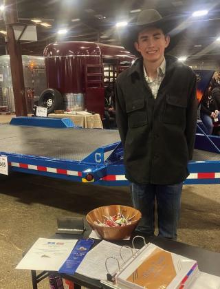 Childress High School’s Tripp Tippett receives a blue ribbon for his blue dovetail trailer at the San Antonio Stock Show’s Junior Agricultural Mechanics Show, where over 1,325 projects were entered by 1,680 students representing 272 schools.
