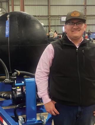 Childress High School Future Farmers and America (FFA) member Jacob Renterria receives a blue ribbon for his water trailer, entered in San Antonio Stock Show’s Junior Agricultural Mechanics Show.