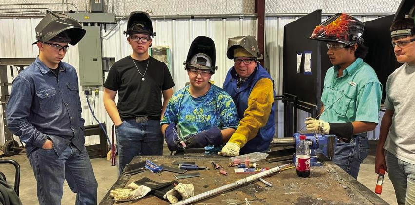 Clarendon College Director of Industrial Maintenance and Welding Mark Simmons, center, recently visits Memphis High School agriculture teacher Ed Bailey’s class, teaching the students new welding techniques. Photo Courtesy of Memphis ISD