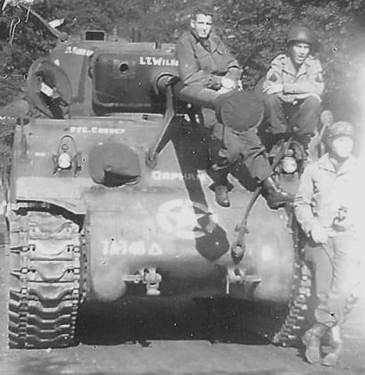 Soldiers wait in anticipation at Lt. B.V. Wilson’s tank.
