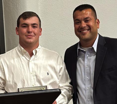 Student of the Year Caleb Strickland, left, accepts his award from Wellington High School Principal Jermaine Cantu.