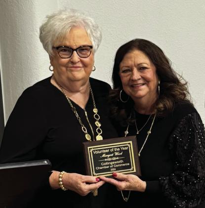 Volunteer of the Year Margret Wood, right, accepts her award from the 2023 Volunteer of the Year, Nancy Harris.