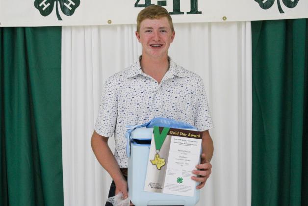 Sterling Bruce receives the Gold Star Award — the highest achievement award a Texas 4-H member can receive — at the 2025 Childress County 4-H Year End Banquet Monday, Aug. 25 at Fair Park City Auditorium. The Red River Sun/ElizabethTanner