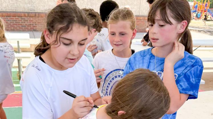 Donned in white T-shirts, Childress Elementary School fourth-grade students become walking yearbooks, letting fellow students sign their names on their backs. CHILDRESS ELEMENTARY SCHOOL