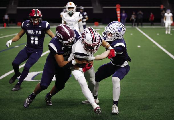 Wa-Ya defensive back Cooper O’Neal, right, of Wills Point High School, tackles Ta’Tanka wide receiver TJ Salinas (center), of Wellington High School, during the first half of the Native American All-Star Football Game at the Ford Center at The Star in Frisco on Tuesday, Jan. 7. Photo by Dallas News Staff Photographer Tom Fox