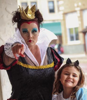 Kayla Heck, dressed as the Queen of Hearts, and Harley Heck, dressed as Alice, bring Wonderland to downtown Childress during Childress Main Street’s Downtown Trickor- Treating event Saturday, Oct. 28. The Red River Sun/Elizabeth Tanner