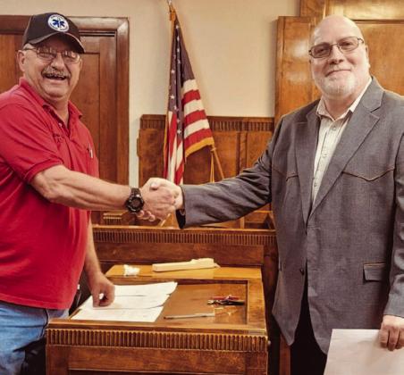 Collingsworth County Pct. 1 Commissioner Farris Nation, left, congratulates newly elected Collingsworth County Judge Scot Martindale following his oath of office, administered by Nation.