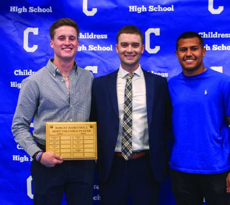 Head boys’ basketball coach Wayne Parker, center, awards Bobcat Basketball Offensive Most Valuable Player Aiden Allen, left, and Bobcat Basketball Defensive Most Valuable Player Isaiah Jalomo, right.