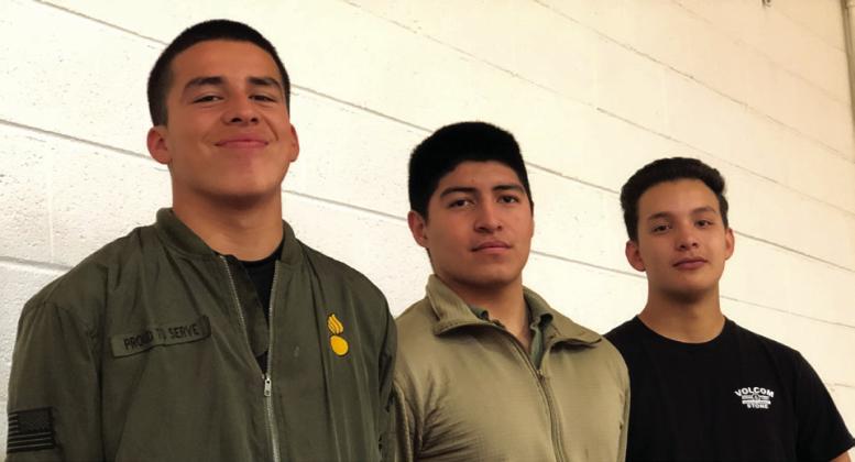 Seniors Juan Vazquez, left, Gael Rodriguez and Anthony Munoz have already enlisted in the U.S. Army and receive recognition during the Veterans Day event.