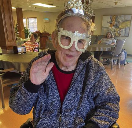 Wellington Care Center residents, along with volunteer Jo Anne Kershner ring in the new year with a few rounds of dominos while others surfed the internet via laptop and talked on the cell phone. Residents also sang “Auld Lang Syne” and enjoyed brownies and sparkling cider at the recent New Year’s party. Courtesy Photo