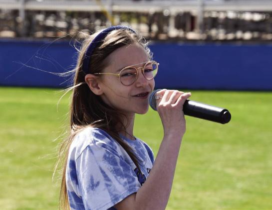 Play ball! Monson Music Studio’s Selah Smith, daughter of Stran and Jennifer Smith, of Childress, performs the National Anthem at the recent Childress Lady Cat softball game in Childress. Photo by Lori Rabe
