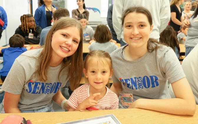 Kindergarteners, seniors team up for Kindergarten Signing Day