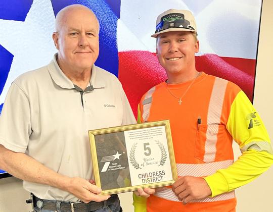 Texas Department of Transportation (TxDOT) Collingsworth County Maintenance Crewmember Creed Riley, right, accepts a five-year service award from TxDOT Childress District Engineer Darwin Lankford.