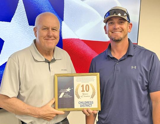 Texas Department of Transportation (TxDOT) Childress County Maintenance Crewmember Jason Willis, right, accepts a 10-year service award from TxDOT Childress District Engineer Darwin Lankford.