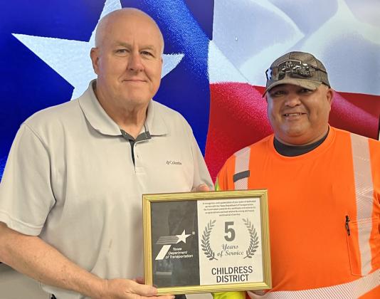Texas Department of Transportation (TxDOT) Childress County Maintenance Crewmember Michael Sanchez, right, accepts a five-year service award from TxDOT Childress District Engineer Darwin Lankford.