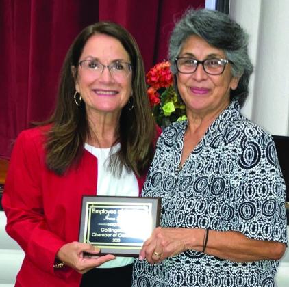 Karen Caldwell, left, bestows Irma Thomas with Employee of the Year.