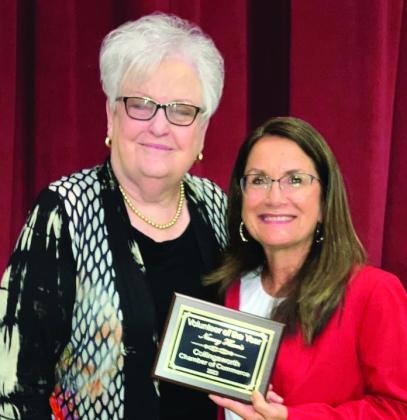 Karen Caldwell, left, bestows Irma Thomas with Employee of the Year.