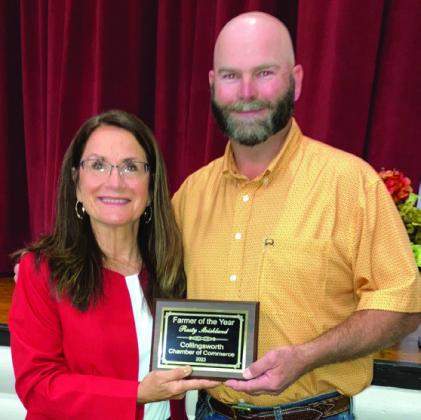 Rusty Strickland, right, accepts Farmer of The Year from Karen Caldwell.