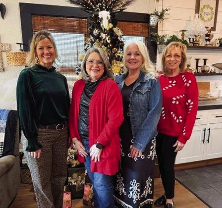 Receiving Hearts United Give Support (HUGS) Holiday Home Tour supporters at the rural Huntress home are HUGS volunteers Amy Inman, left, Linda Porter, Debbie Huntress and Lennie Statham. Hearts United Give Support
