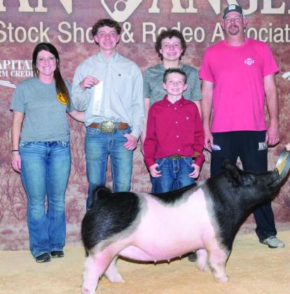 Carvin Wischkaemper, a member of the Wellington High School Class of 2025, places third with his cross gilt and made the sale, places 12th overall in the heavyweight division, at the recent San Angelo Stock Show and Rodeo. Carvin is congratulated by his parents, Megan and Jason Wischkaemper, and his brothers, Easton and Holden Wischkaemper.