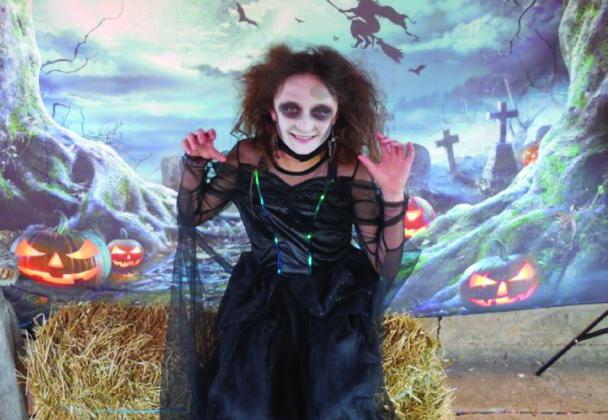 Lily Strasro, dressed as a witch, takes the female child first-place prize of $50.