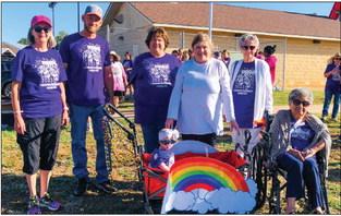 Cancer survivors, including Lesa Tarver, left, Johan Dyck, Candy Powell, Kaydence Faith Mixon, Tammy Sawyer, of Lubbock, Fran Eigenmann and Sandra Torrez, prepare to take their place of honor for the first lap of the Wellington Professional Women’s Club (WPWC) Bubble Run. The Red River Sun/Bev Odom
