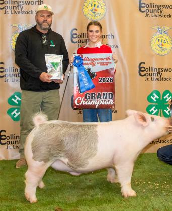 Maggie Tillman shows the Grand Champion Swine, purchased by Barry Long Farms at the Premium Sale.