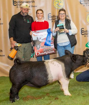 For her brother, Travis Tillman, Maggie Tillman displays the Reserve Champion Swine, purchased by Wellington State Bank at the Premium Sale.