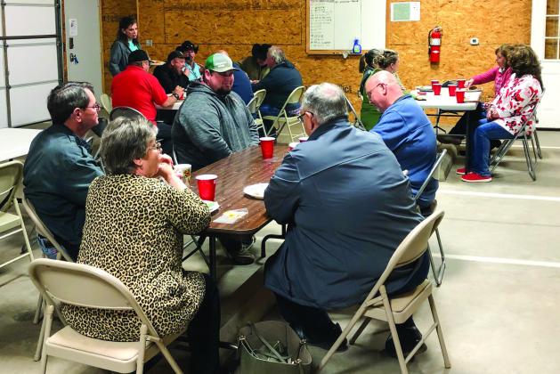 Collingsworth County Commissioners Farris Nation, Jim Ellis and Joel Sherwood serve burgers, drinks and dessert to county employees and guests at the Wellington Emergency Medical Service barn Monday, Dec. 19. The meal provided a time of fellowship for the staff during the holiday season. The Red River Sun/Bev Odom