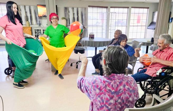 Situated in the dining room and attired in “Granny Pants,” Wellington Care Center staff encourage residents to toss balls into oversized, wearable pants. Fun and laughter filled the room, and everyone had a great time working together, staying active and sharing plenty of smiles. Wellington Care Center