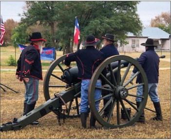 Living history soldiers prepare to fire the canon.