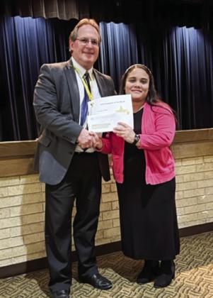 Memphis Independent School District (ISD) Superintendent William Alexander, left, names Austin Elementary School firstgrade educator Sandra Rojas the March Memphis ISD Employee of the Month.
