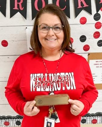 Accepting a walnut pen and pencil set for 20 years of service to Wellington Independent School District is Dottie Davis. Not pictured: Landey Waters.