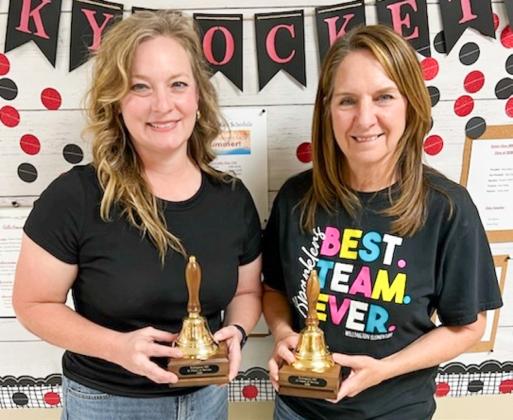 A brass bell keepsake notes 15 years of service to Wellington Independent School District for Marnie Kane, left, and Diann Williams.