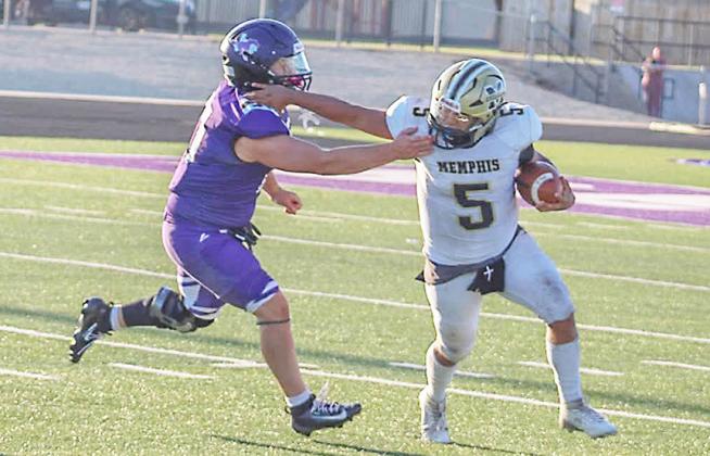 A Memphis Cyclone tries to fend off a Benjamin defense player last week during the six-man season opener. Memphis will face Follett Sept. 4 and then Vernon JV on Sept. 9, both games will be on the road.