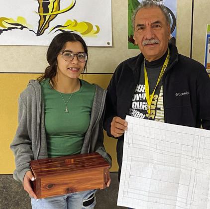 Memphis Middle School eighth-grader Alexis Diaz shows off her recent woodworking skills, which she learned in educator Ramio Salas’ class. Diaz designed, drew up and built the project. Photo Courtesy of Memphis ISD