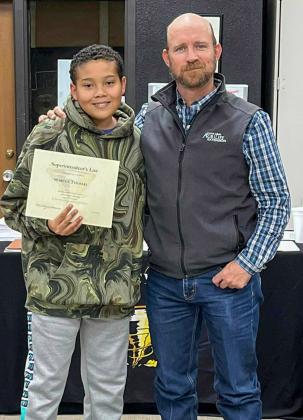 Memphis Middle School seventh-grader Marcus Thomas accepts the Superintendent’s List designation from Memphis ISD Board of Trustees member Josh Brooks.