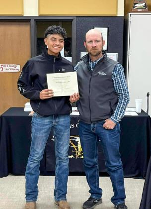 Memphis Middle School eighth-grader Richard Garcia accepts the Superintendent’s List designation from Memphis ISD Board of Trustees member Josh Brooks.