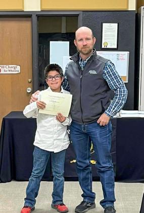 Memphis Middle School sixth-grader Javier Pizana accepts the Superintendent’s List designation from Memphis ISD Board of Trustees member Josh Brooks.