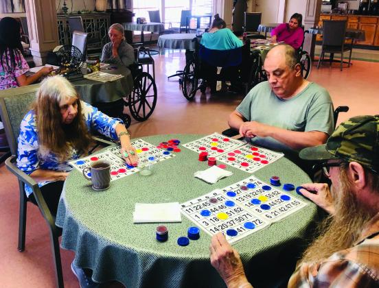 Wellington Care Center Activity Director Thalia Herrera calls a competitive game of bingo during a recent afternoon in the dining room of the facility. Regardless of the activities offered, certain residents never pass up an opportunity to play bingo. The Red River Sun/Bev Odom