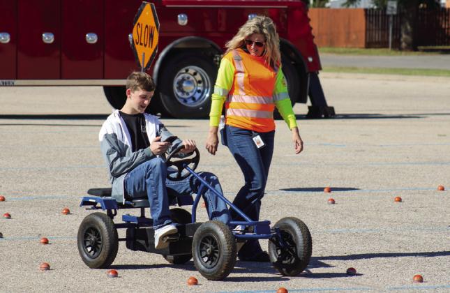 Texas Department of Transportation (TxDOT) Childress District Traffic Safety Specialist Nicole Tyler acts as a “distractor” during a distracted driving drill with Childress High School student Rider Carroll.